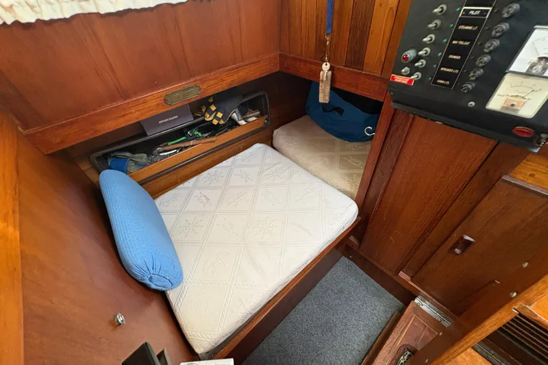 Slide: The Image of Cozy cabin interior of 1977 Folkes Full Keel Offshore Cutter with wooden paneling and cushioned seating. - 60