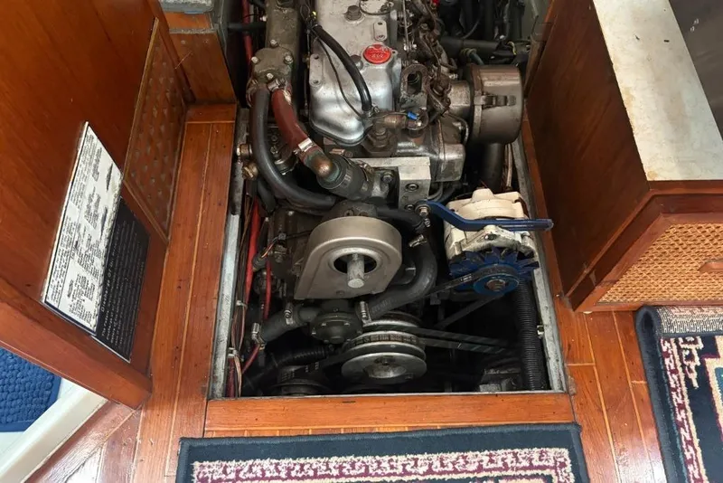 Slide: The Image of Engine compartment of a 1977 Folkes Full Keel Offshore Cutter sailboat, showcasing mechanical components. - 65