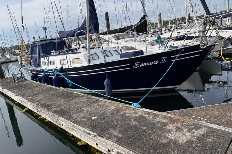 Slide: The Image of 1977 Folkes Full Keel Offshore Cutter "Samara II" docked at marina. - 9