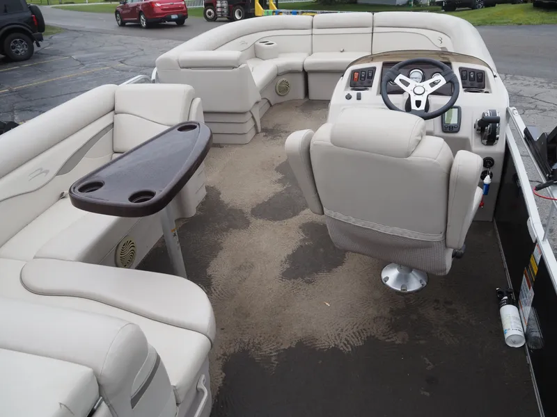 Slide: The Image of Interior of a 2015 Bennington S21 pontoon boat with steering wheel and seating. - 10