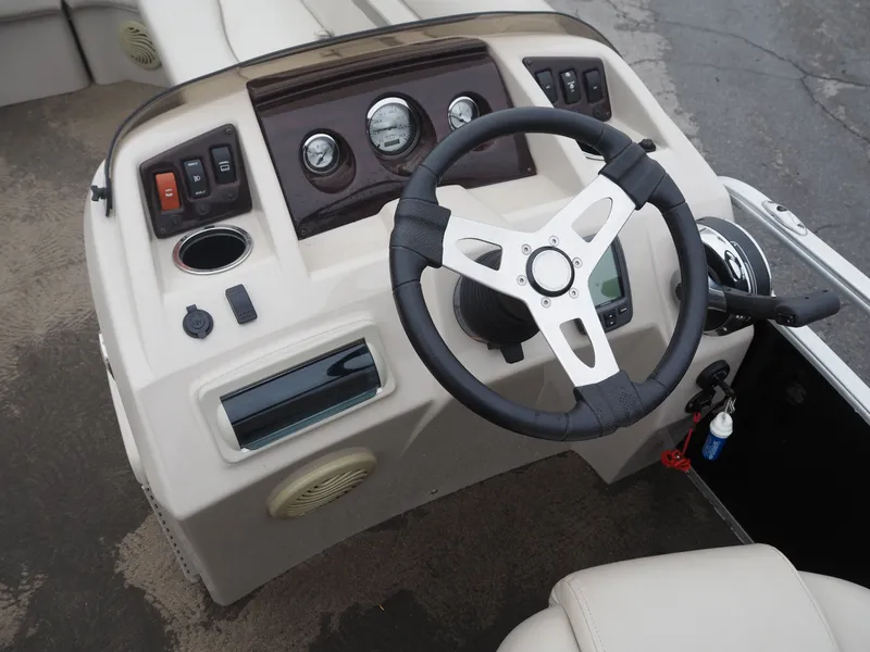 Slide: The Image of 2015 Bennington S21 boat console with steering wheel and controls. - 11