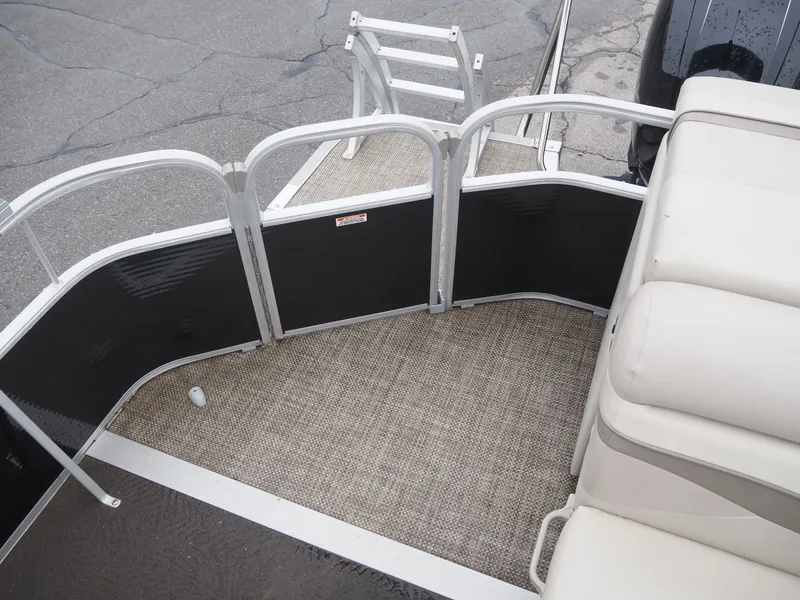 Slide: The Image of 2015 Bennington S21 pontoon boat with carpeted deck and seating area. - 9