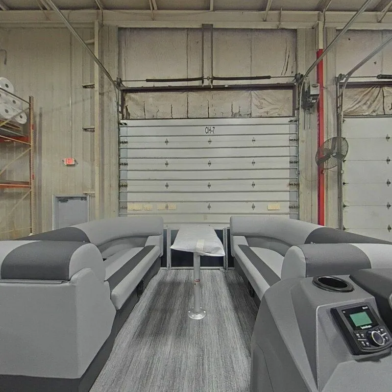 Slide: The Image of Interior view of a 2026 Bennington 22SSR pontoon boat in a warehouse. - 10