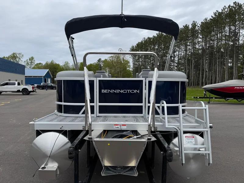 Slide: The Image of Rear view of 2026 Bennington 22SSR pontoon boat in a parking lot. - 23