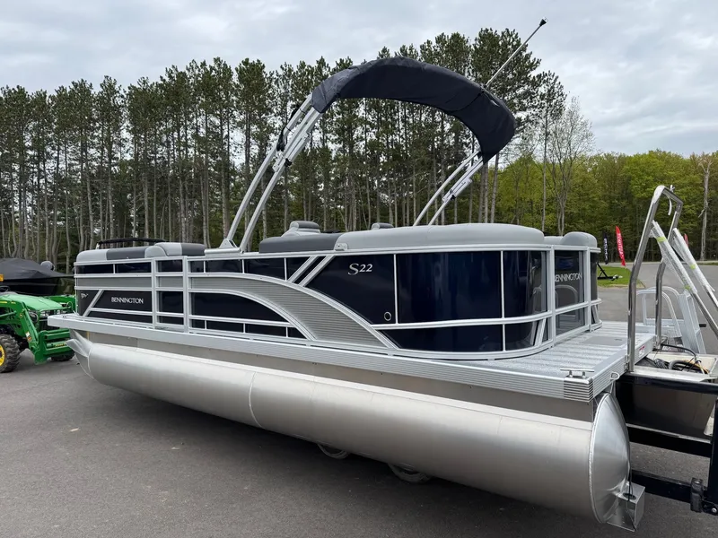 Slide: The Image of 2026 Bennington 22SSR pontoon boat parked in front of trees. - 24