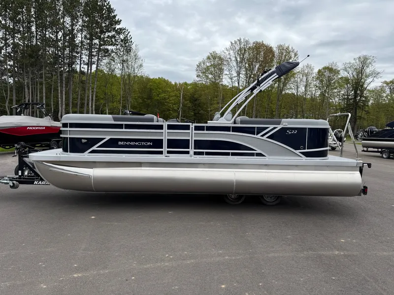 Slide: The Image of 2026 Bennington 22SSR pontoon boat parked on a trailer outdoors. - 25