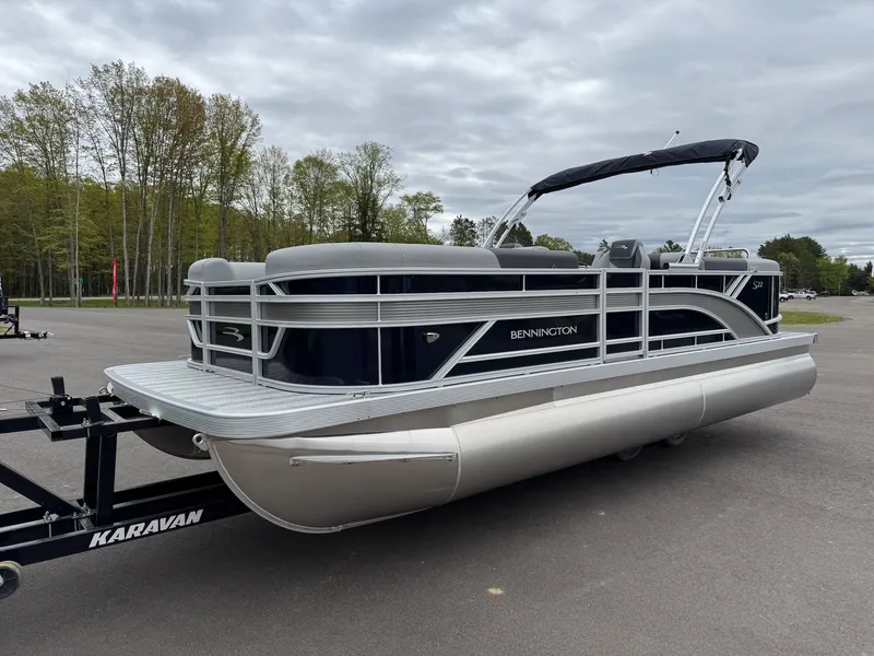 Slide: The Image of 2026 Bennington 22SSR pontoon boat parked on trailer outdoors. - 26