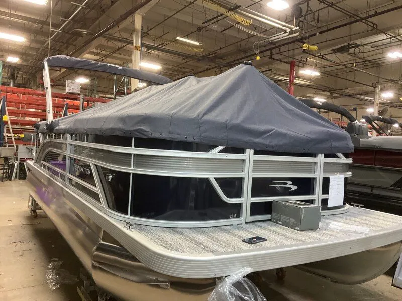 Slide: The Image of 2026 Bennington 22SSR pontoon boat covered in warehouse. - 8