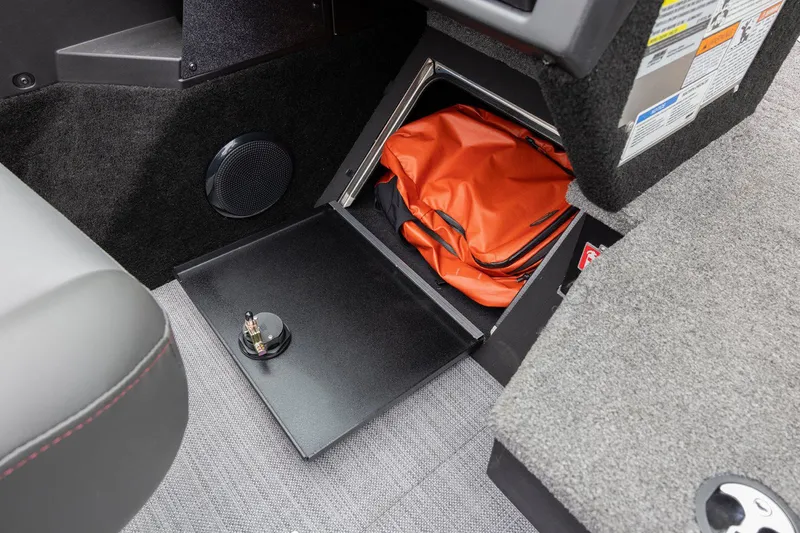 Slide: The Image of Storage compartment in 2026 Alumacraft Trophy 195X Sport with orange bag. - 13