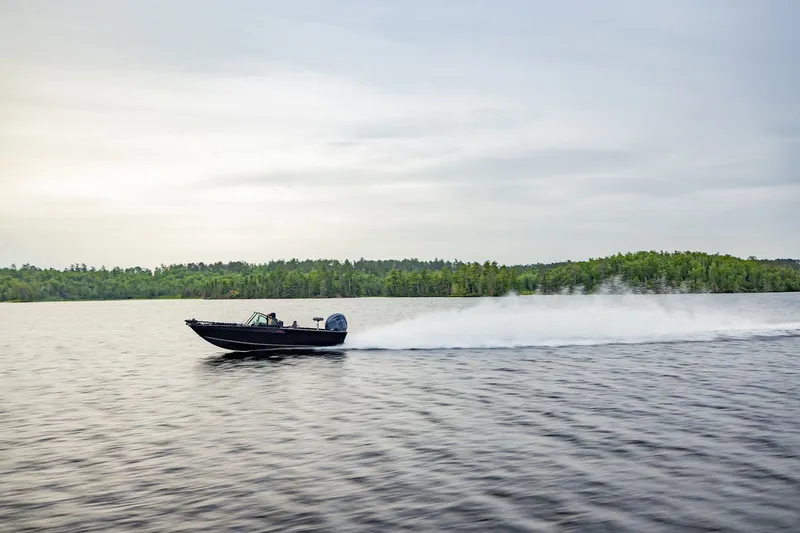 Slide: The Image of 2026 Alumacraft Trophy 195X Sport on a serene lake. - 22