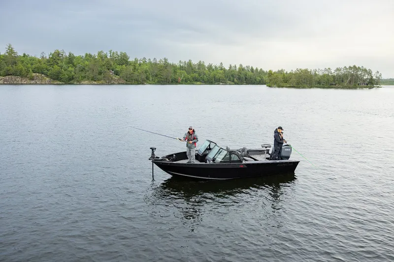 Slide: The Image of 2026 Alumacraft Trophy 195X Sport fishing on a serene lake. - 23