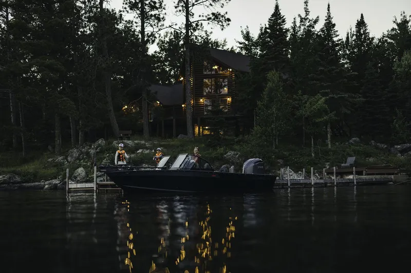 Slide: The Image of Alumacraft Trophy 195X Sport 2026 boat on lake at dusk. - 24