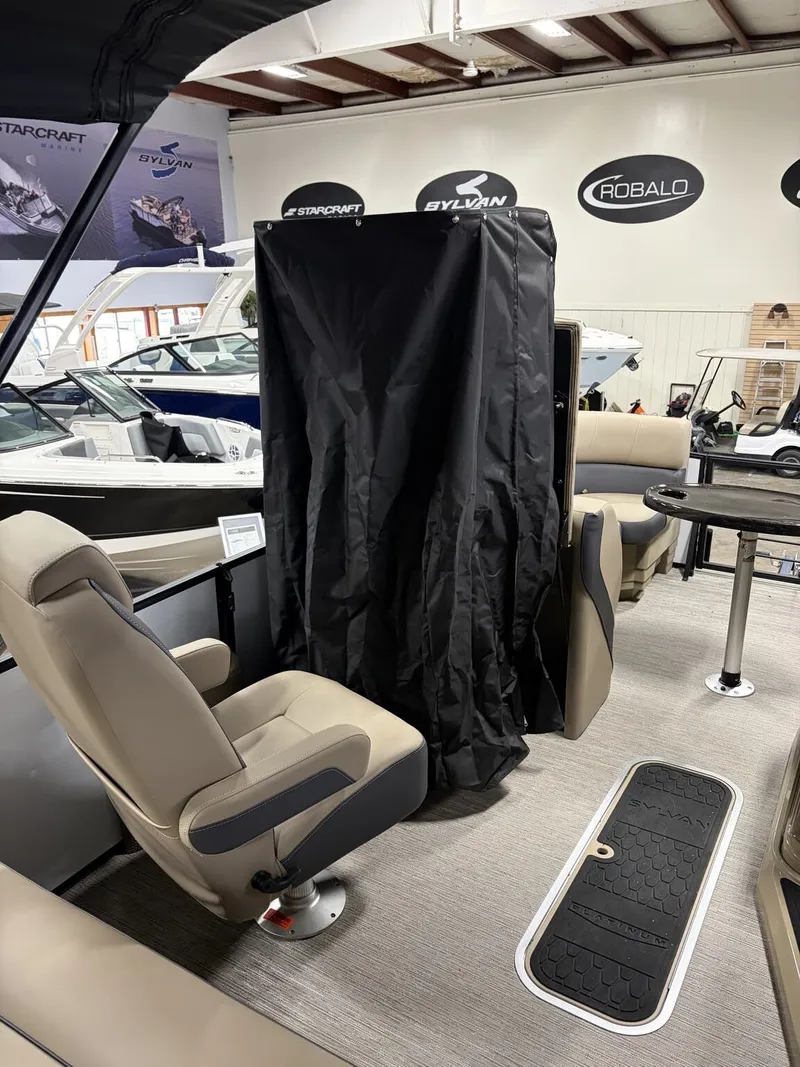 Slide: The Image of Interior view of Sylvan Mirage X 2026 pontoon boat in showroom. - 10
