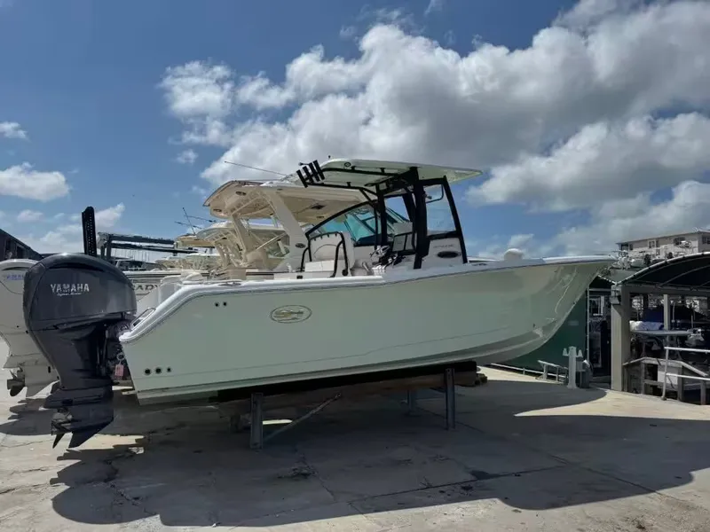 The Image of 2023 Sea Hunt Ultra 275 SE boat docked under sunny skies. - 1
