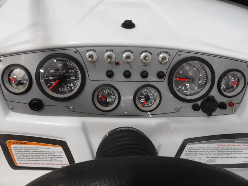 Slide: The Image of Dashboard of a 2022 Tahoe 185 boat with gauges and switches. - 16