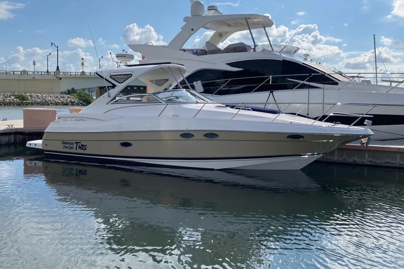 The Image of 2007 Regal 3760 Commodore yacht docked in a marina under a clear blue sky. - 0