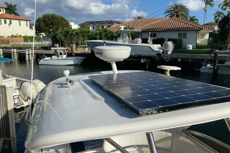 Slide: The Image of 2007 Regal 3760 Commodore with solar panel docked in a marina. - 11