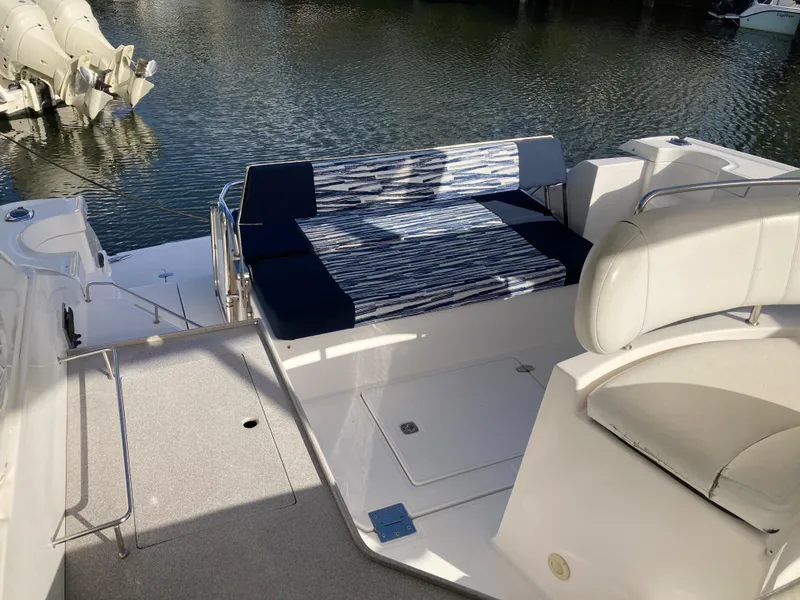 Slide: The Image of 2007 Regal 3760 Commodore boat interior with seating, docked by the water. - 13