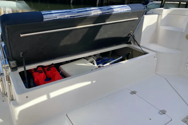 Slide: The Image of Open storage compartment on 2007 Regal 3760 Commodore boat, showing life jackets and equipment. - 16