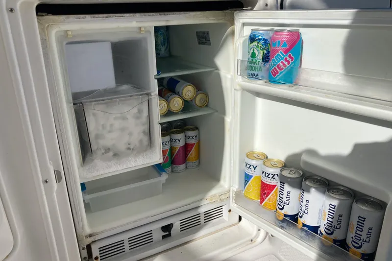 Slide: The Image of Mini fridge stocked with drinks on a 2007 Regal 3760 Commodore boat. - 25