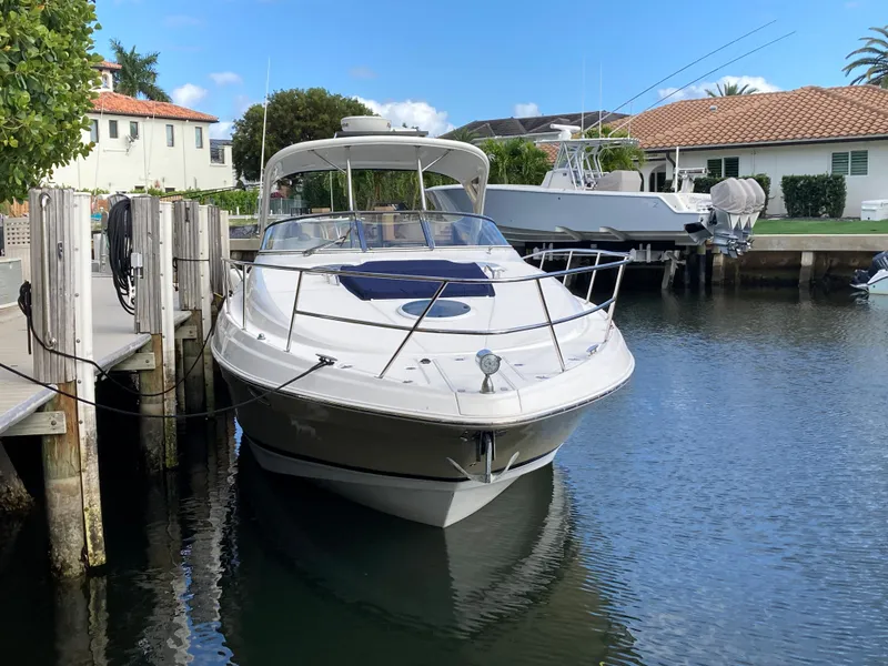 Slide: The Image of 2007 Regal 3760 Commodore yacht docked in a serene canal setting. - 3