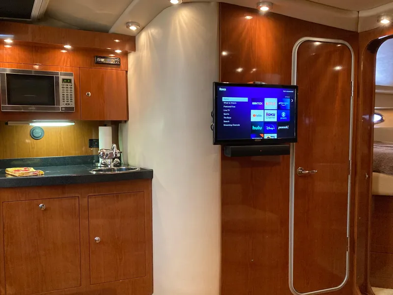 Slide: The Image of 2007 Regal 3760 Commodore yacht interior with kitchenette and mounted TV. - 31
