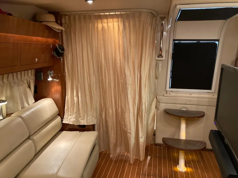 Slide: The Image of Interior of 2007 Regal 3760 Commodore yacht with beige seating and wooden accents. - 37