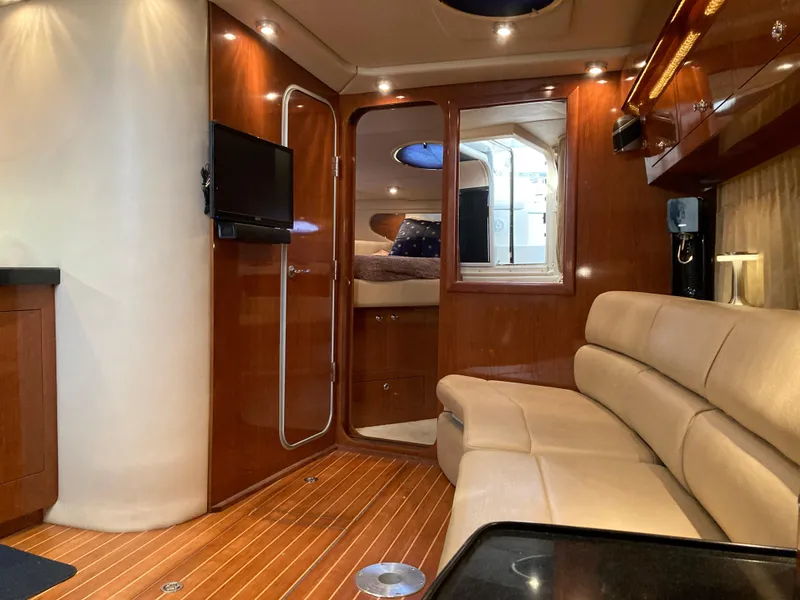 Slide: The Image of Luxurious interior of 2007 Regal 3760 Commodore yacht with wood finish and plush seating. - 38