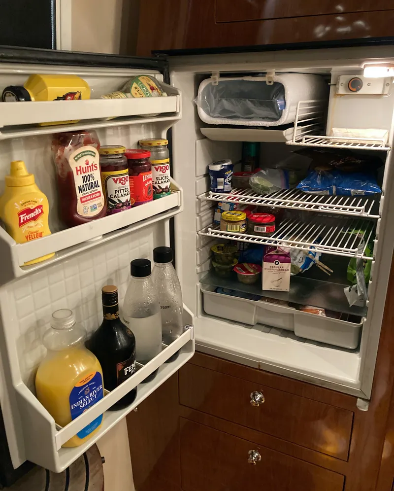 Slide: The Image of Open refrigerator in a 2007 Regal 3760 Commodore, stocked with various food and drinks. - 42