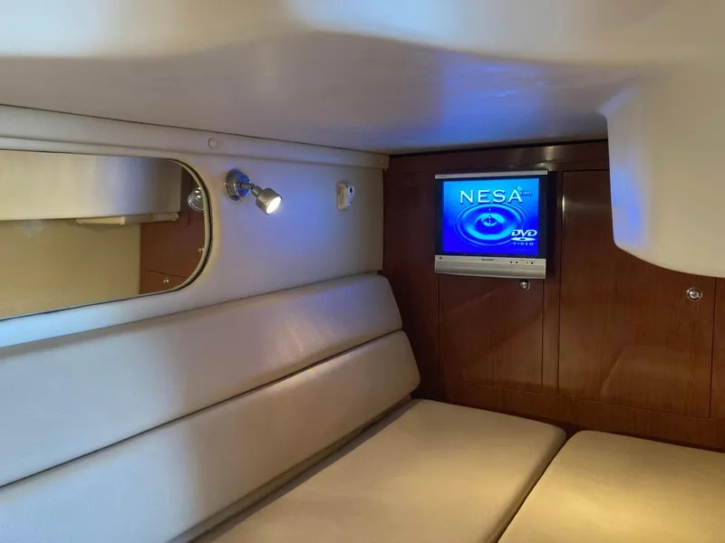 Slide: The Image of 2007 Regal 3760 Commodore cabin with TV, sofa, and wall light. - 46