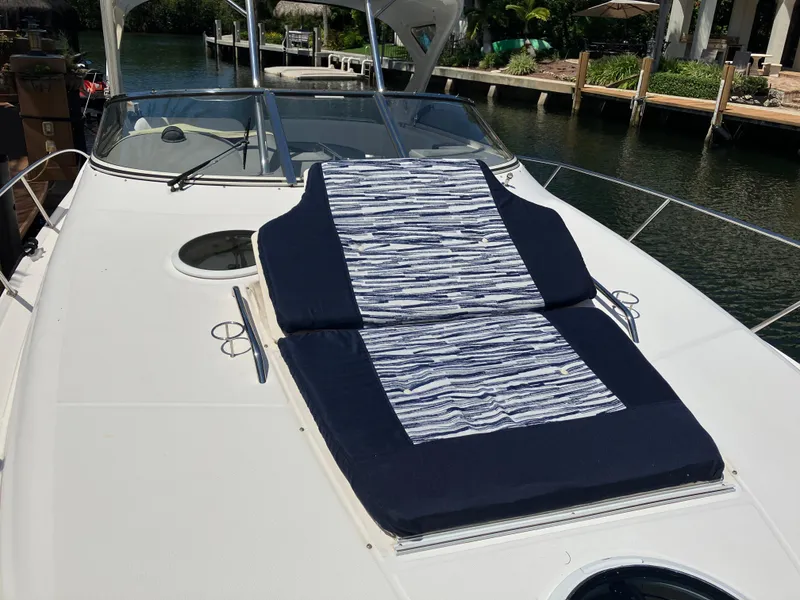 Slide: The Image of 2007 Regal 3760 Commodore yacht with sunbed on deck, docked by a canal. - 6
