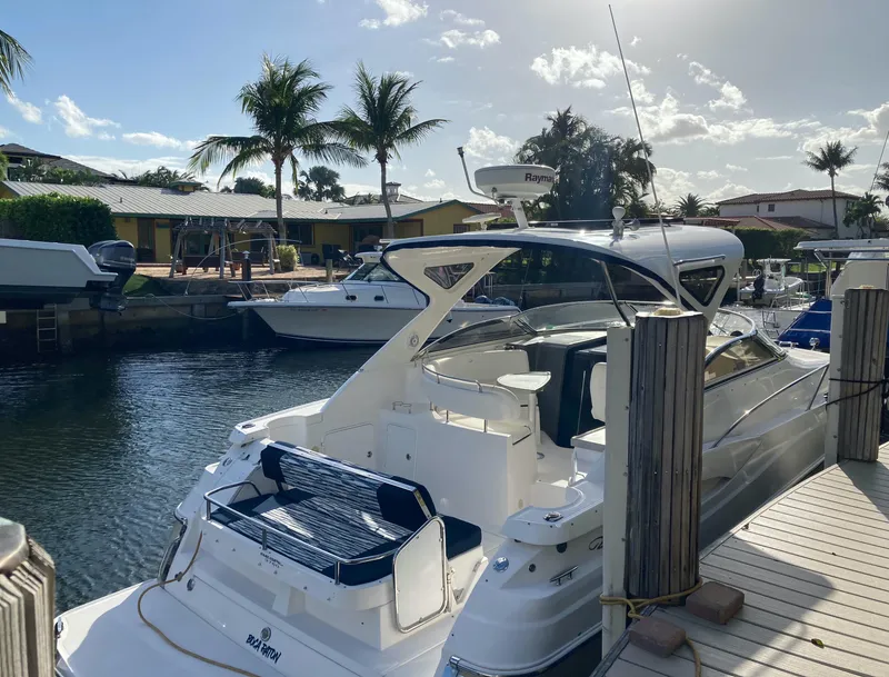 Slide: The Image of 2007 Regal 3760 Commodore yacht docked in sunny marina with palm trees. - 8