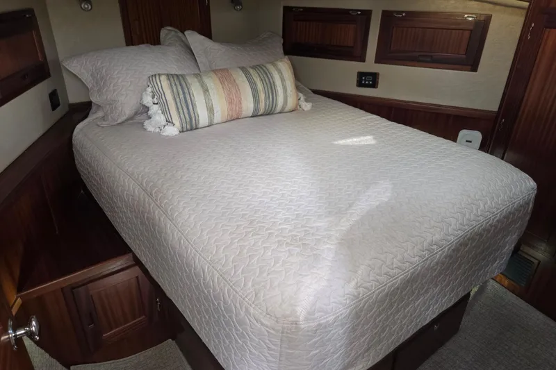 Slide: The Image of Cozy bedroom interior of 2012 American Tug 365 Flybridge with elegant bedding and wood accents. - 10