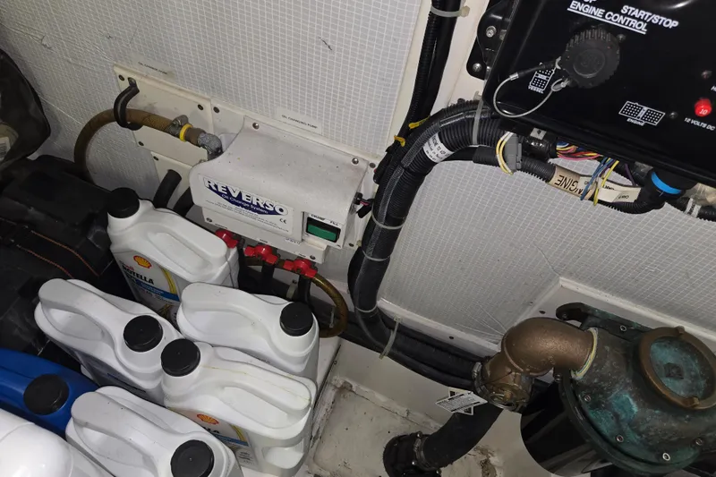 Slide: The Image of Engine room of 2012 American Tug 365 Flybridge with oil containers and control panel. - 100