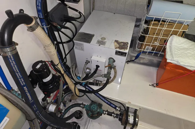 Slide: The Image of Engine room of a 2012 American Tug 365 Flybridge with visible plumbing and equipment. - 104