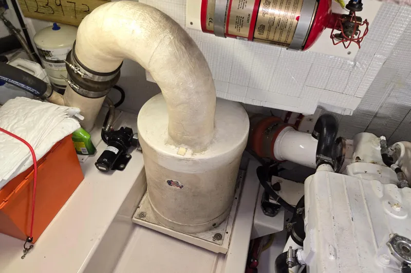 Slide: The Image of Engine room of 2012 American Tug 365 Flybridge with exhaust system and fire extinguisher. - 106