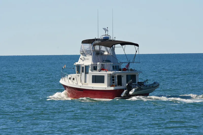 Slide: The Image of American Tug 365 Flybridge 2012 cruising on open water. - 110