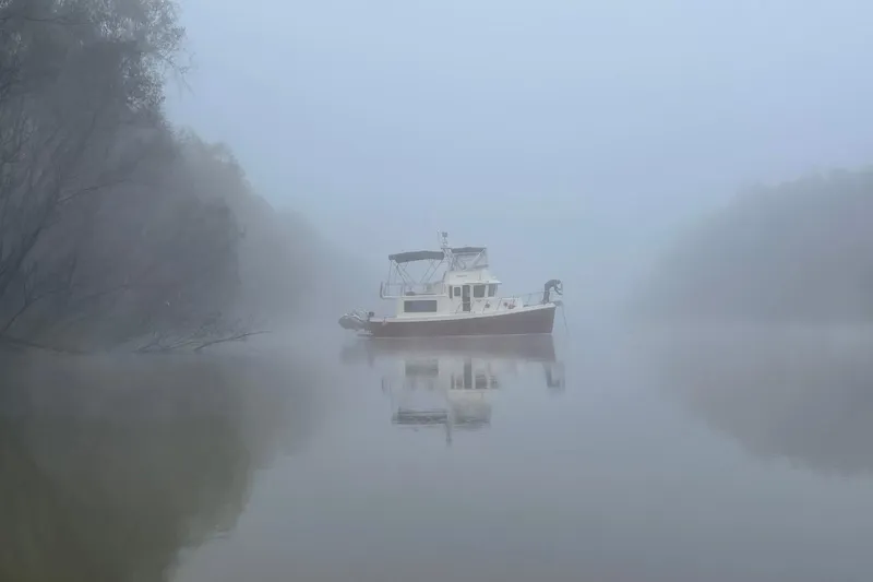 Slide: The Image of Foggy river scene with 2012 American Tug 365 Flybridge boat. - 115