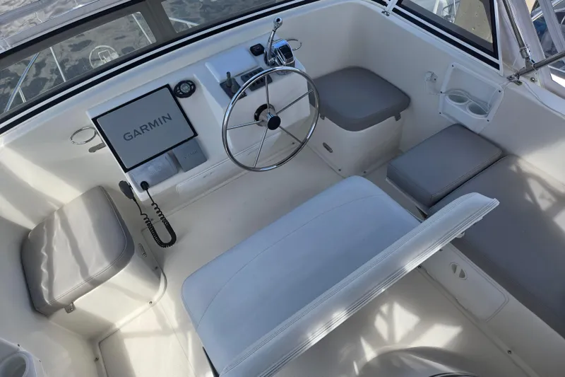 Slide: The Image of 2012 American Tug 365 Flybridge helm with Garmin navigation system and seating. - 13