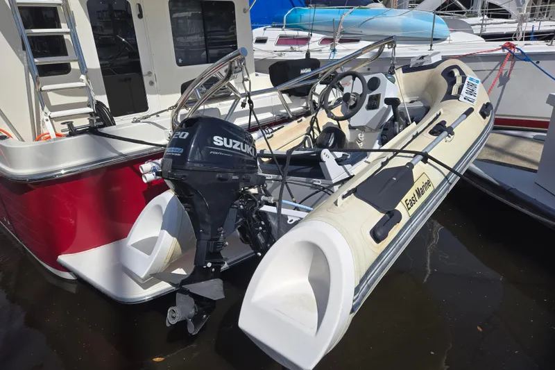 Slide: The Image of American Tug 365 Flybridge 2012 with Suzuki outboard motor and inflatable dinghy. - 15