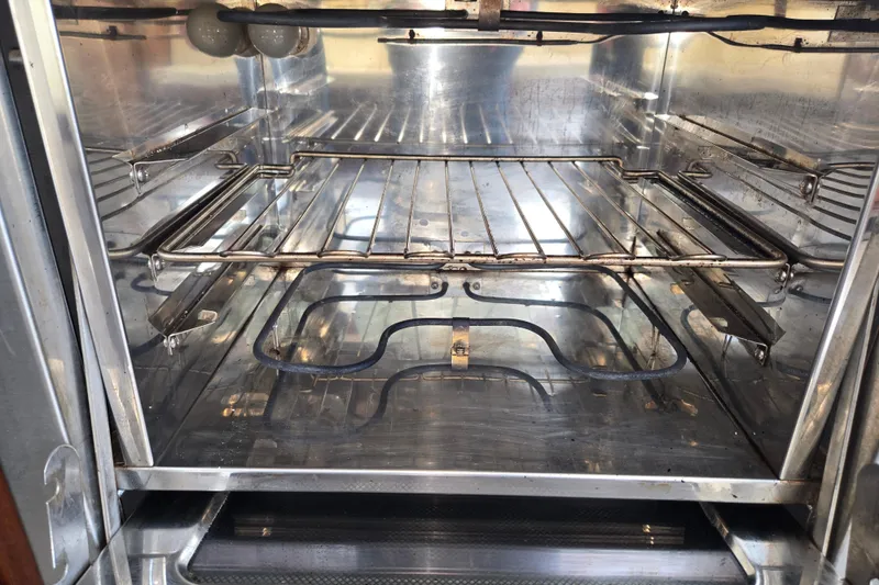 Slide: The Image of Clean stainless steel oven interior with racks, part of 2012 American Tug 365 Flybridge. - 23