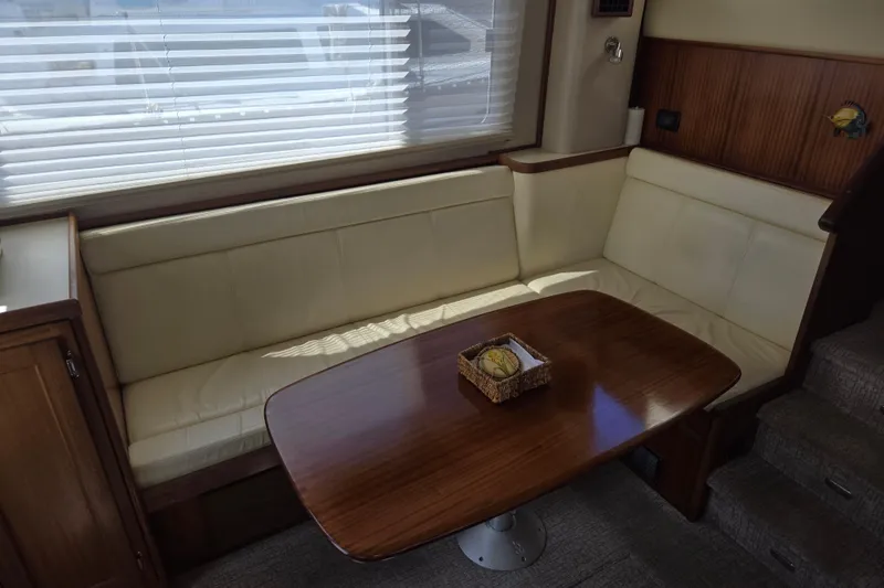 Slide: The Image of Interior of 2012 American Tug 365 Flybridge with cozy seating and wooden table. - 26