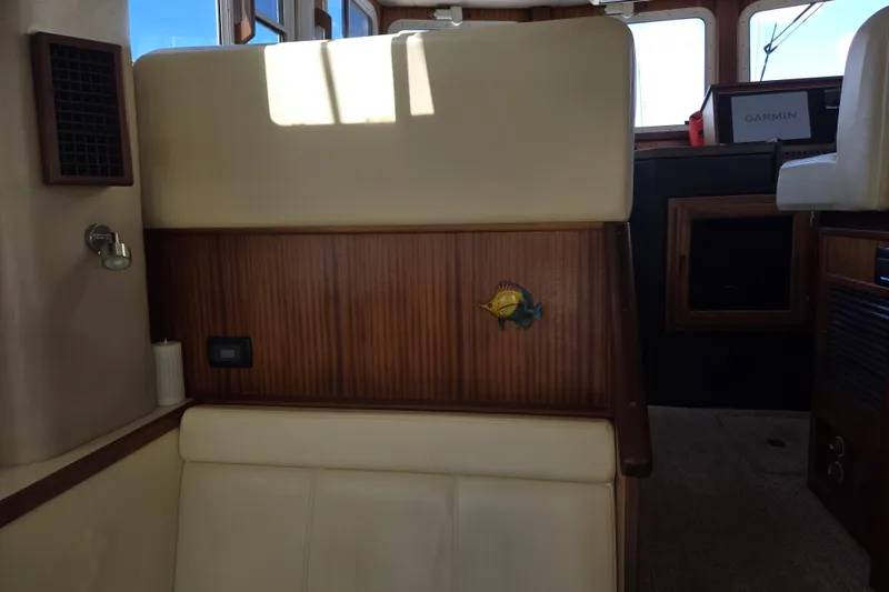 Slide: The Image of Interior of 2012 American Tug 365 Flybridge with wood paneling and fish decor. - 28