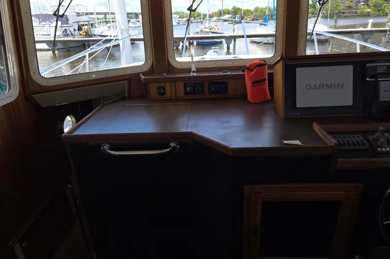 Slide: The Image of Interior helm of 2012 American Tug 365 Flybridge with Garmin navigation system. - 32