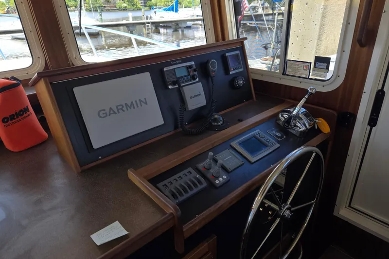 Slide: The Image of American Tug 365 Flybridge 2012 helm with Garmin navigation system and controls. - 33