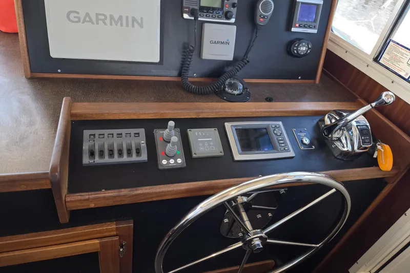 Slide: The Image of Helm of 2012 American Tug 365 Flybridge with Garmin navigation equipment. - 36