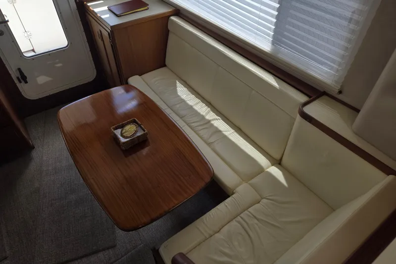 Slide: The Image of Interior of 2012 American Tug 365 Flybridge with cozy seating and wooden table. - 4