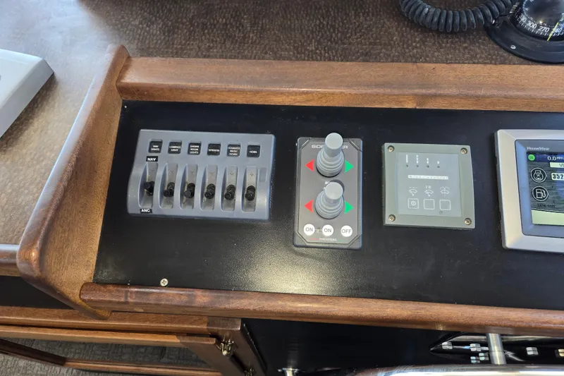 Slide: The Image of Control panel of a 2012 American Tug 365 Flybridge with switches and navigation instruments. - 41