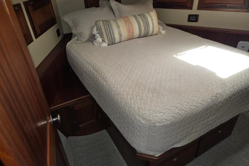 Slide: The Image of Cozy bedroom in 2012 American Tug 365 Flybridge with quilted bedding and decorative pillow. - 44