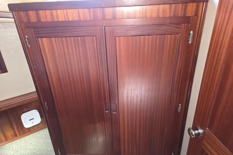 Slide: The Image of Wooden cabinet doors inside a 2012 American Tug 365 Flybridge boat interior. - 48